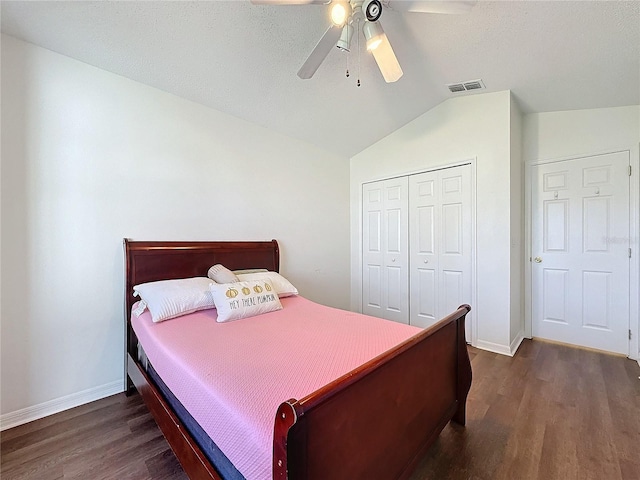 bedroom with a closet, vaulted ceiling, ceiling fan, and dark hardwood / wood-style floors