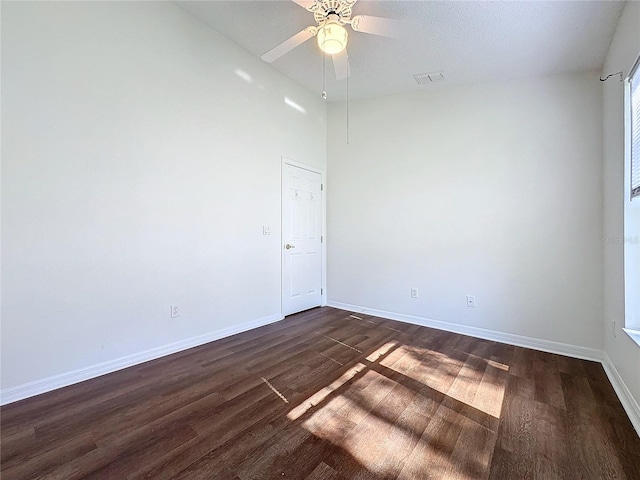 unfurnished room featuring ceiling fan and dark hardwood / wood-style flooring