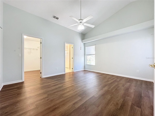 unfurnished bedroom featuring high vaulted ceiling, ceiling fan, a spacious closet, dark hardwood / wood-style flooring, and a closet