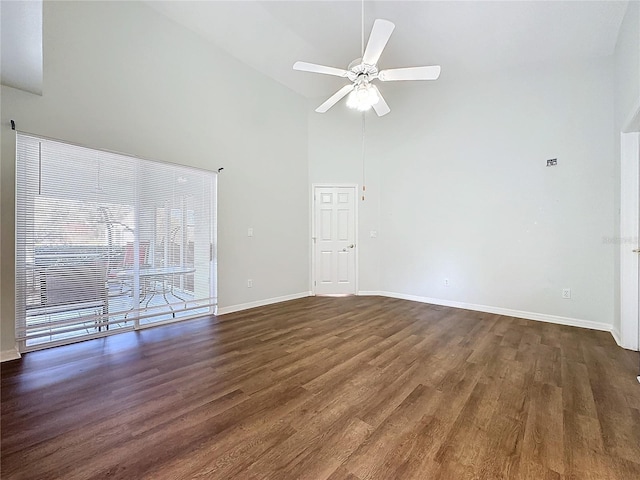 unfurnished living room with dark hardwood / wood-style flooring, high vaulted ceiling, and ceiling fan