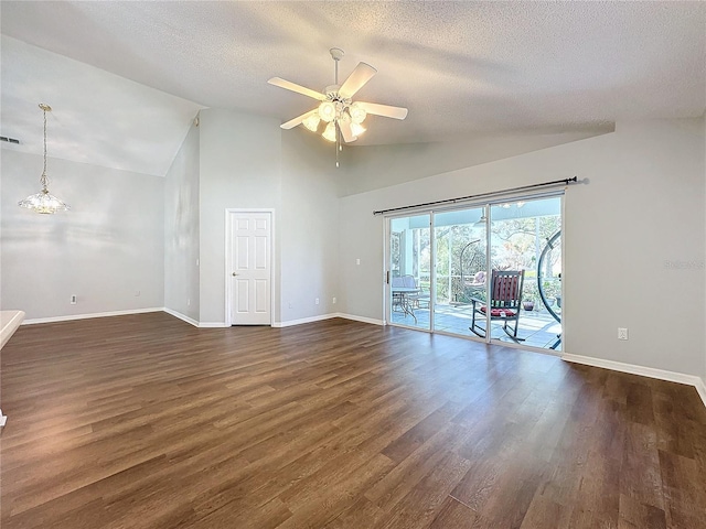 spare room featuring ceiling fan, dark hardwood / wood-style floors, lofted ceiling, and a textured ceiling