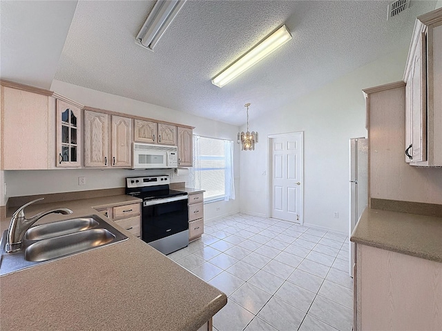 kitchen featuring sink, light tile patterned floors, light brown cabinetry, appliances with stainless steel finishes, and decorative light fixtures