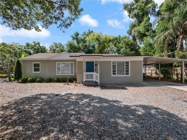 single story home featuring a carport and covered porch