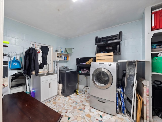 clothes washing area featuring cabinets, light tile floors, and separate washer and dryer