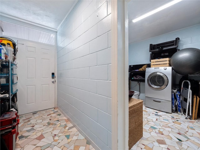 tiled entryway with washer / dryer