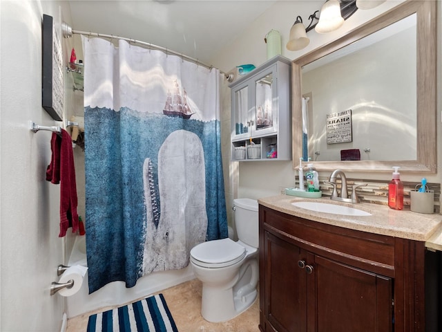 bathroom featuring tile floors, vanity with extensive cabinet space, and toilet