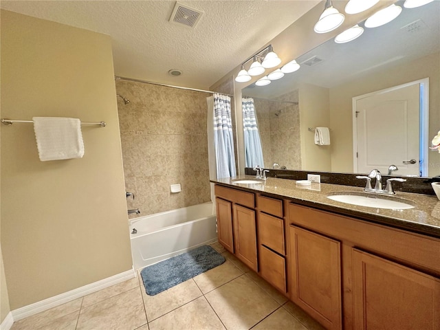 bathroom featuring shower / bath combo, tile patterned floors, a textured ceiling, and vanity