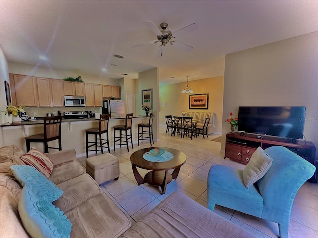 tiled living room with ceiling fan