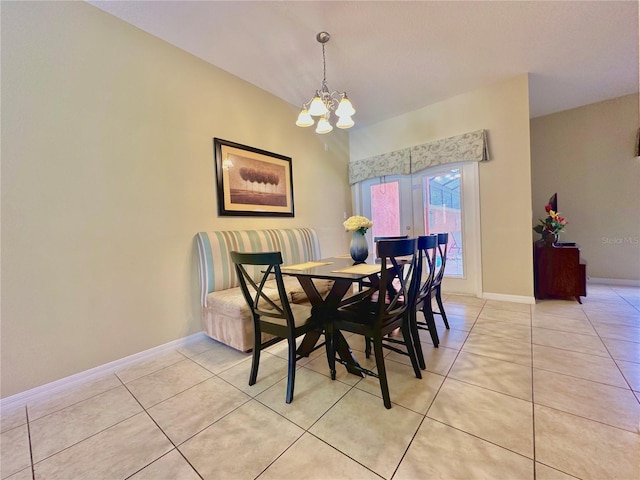 tiled dining space with an inviting chandelier