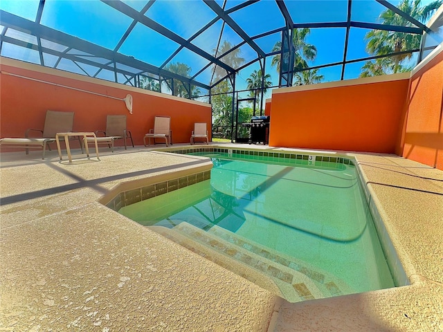 view of pool with a patio and a lanai