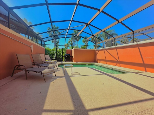 view of swimming pool with a patio and a lanai