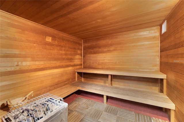 view of sauna / steam room with wooden ceiling and wood walls