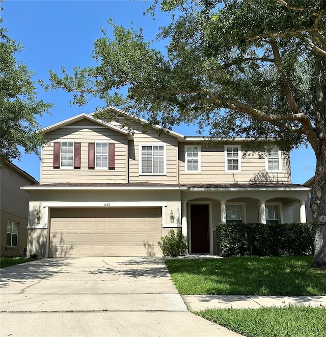 view of front of property with a garage and a front yard