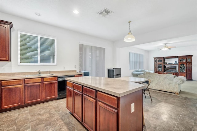 kitchen featuring pendant lighting, sink, ceiling fan, a center island, and black dishwasher