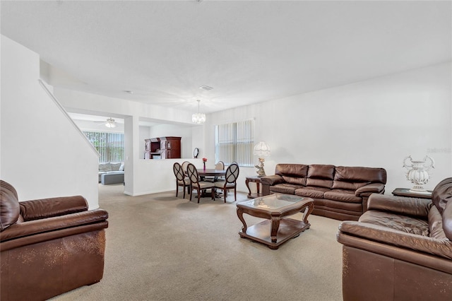 living room with carpet flooring and a notable chandelier