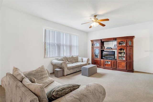 living room with light colored carpet and ceiling fan