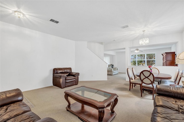 living room with an inviting chandelier and light colored carpet