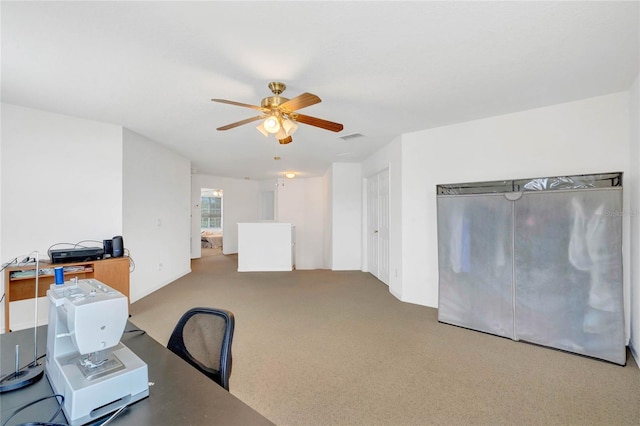 carpeted home office with ceiling fan