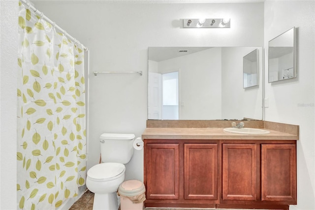 bathroom with vanity, a shower with shower curtain, and toilet