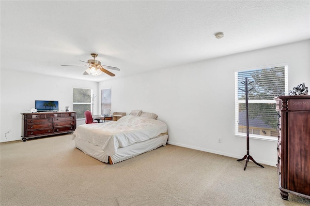 bedroom featuring light carpet and ceiling fan