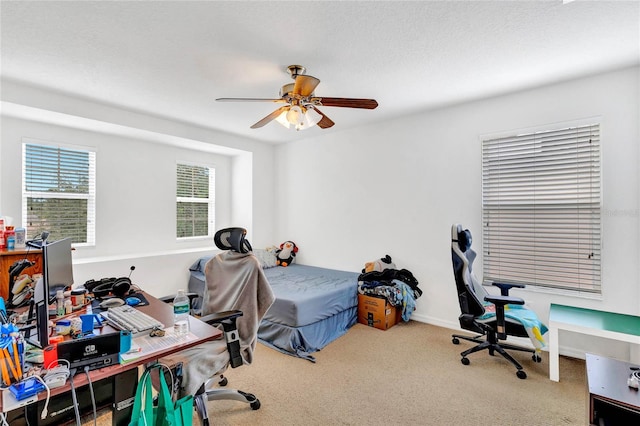 bedroom featuring a textured ceiling, ceiling fan, and carpet