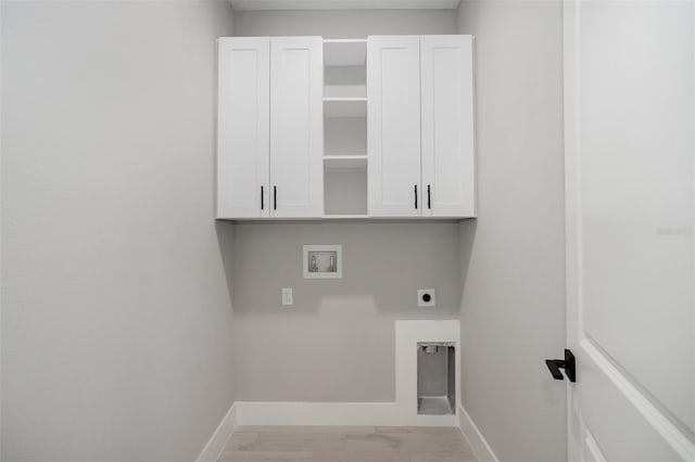 laundry area featuring hookup for a washing machine, electric dryer hookup, and cabinets