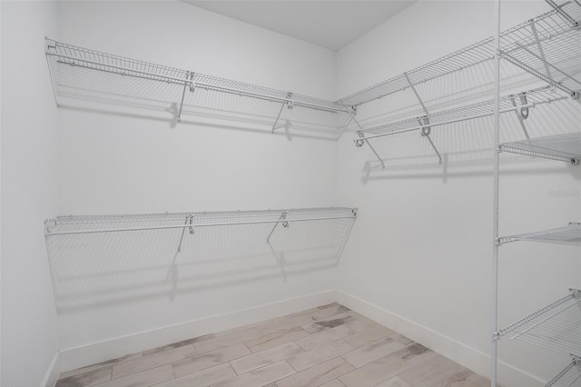 spacious closet featuring hardwood / wood-style flooring