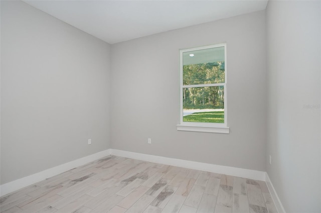 empty room with light hardwood / wood-style flooring