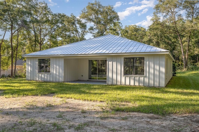 back of property featuring a yard