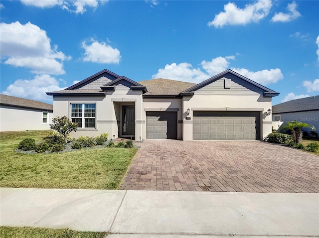 view of front facade featuring a garage and a front lawn