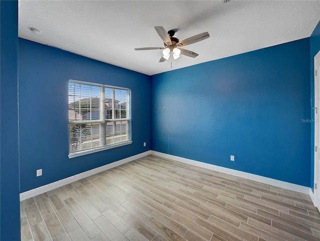 empty room featuring light hardwood / wood-style floors and ceiling fan