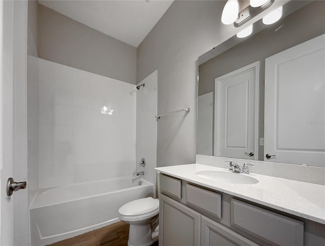 full bathroom featuring wood-type flooring, shower / bathing tub combination, vanity, and toilet