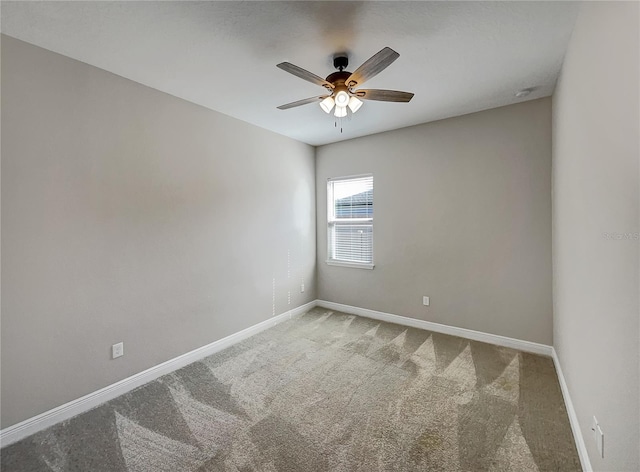 empty room featuring light carpet and ceiling fan