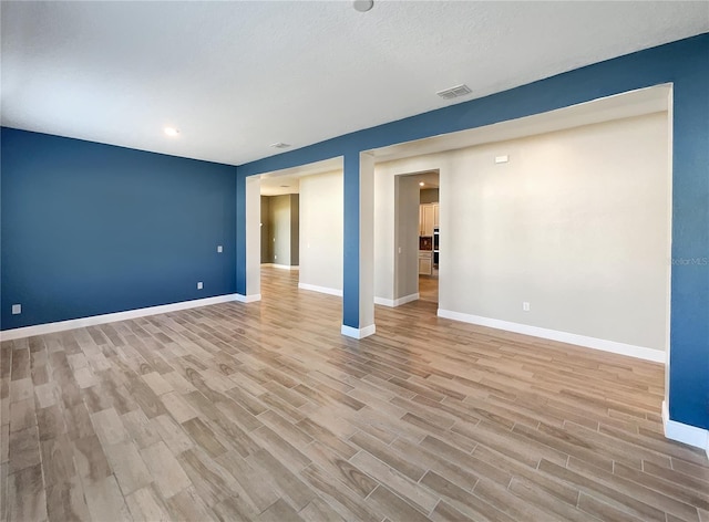 unfurnished room featuring light hardwood / wood-style floors