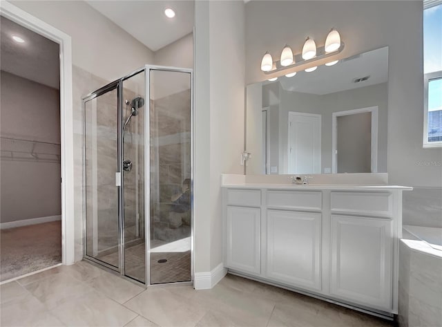 bathroom featuring independent shower and bath, vanity, and tile floors