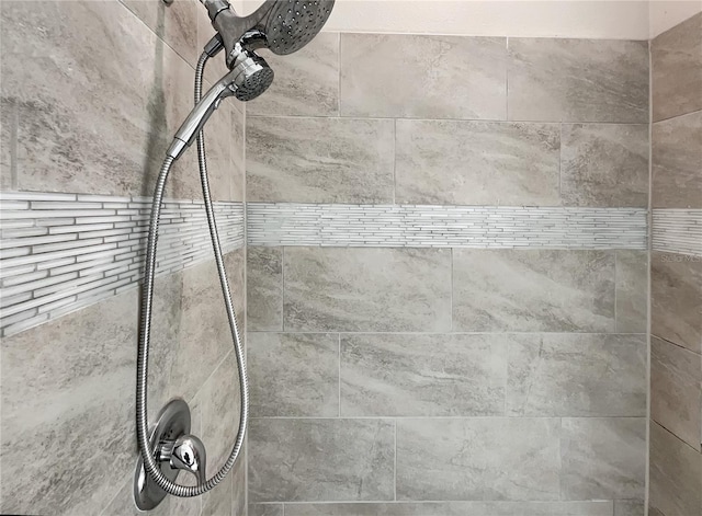 interior details with a tile shower