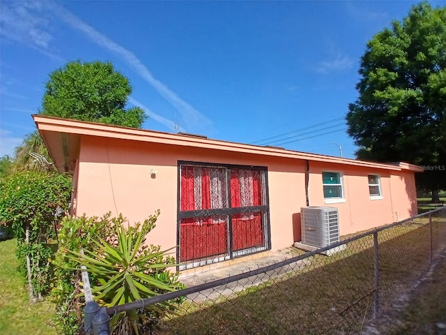 view of side of property with central AC