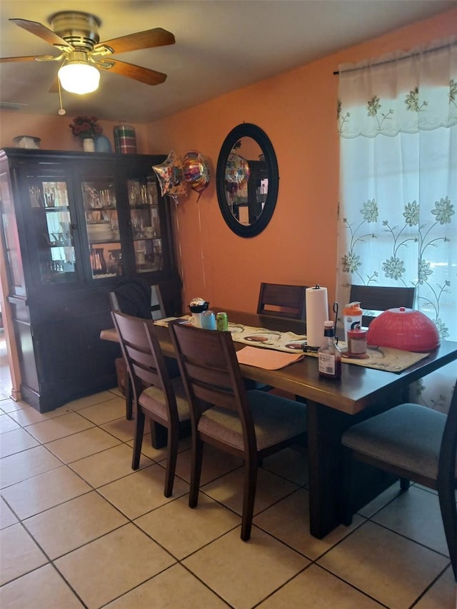 tiled dining room with ceiling fan