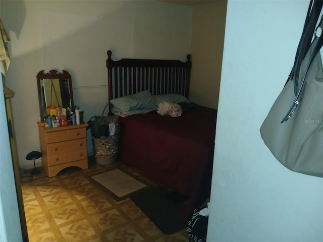 bedroom with light parquet flooring