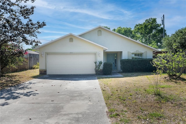 single story home with a front yard and a garage