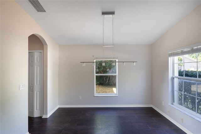 unfurnished room featuring dark hardwood / wood-style flooring