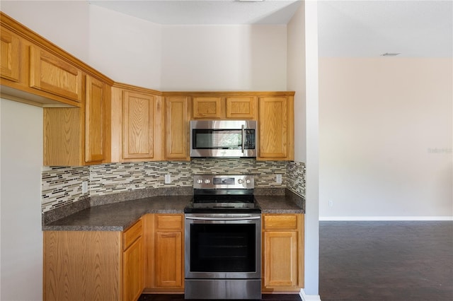 kitchen with appliances with stainless steel finishes and tasteful backsplash