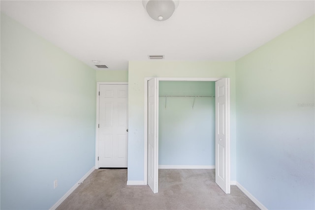 unfurnished bedroom featuring a closet and carpet flooring