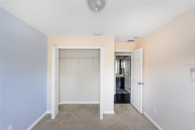 unfurnished bedroom featuring a closet and carpet flooring