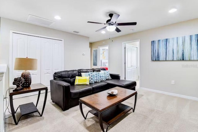 carpeted living room with ceiling fan