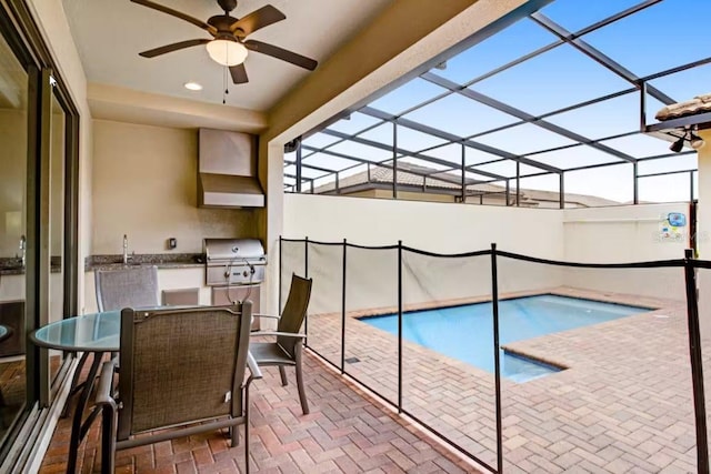 view of swimming pool with a grill, a patio, glass enclosure, and ceiling fan