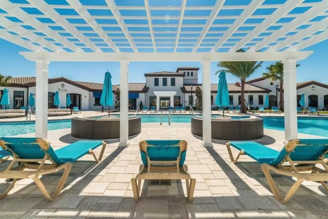 view of terrace with a community pool and a pergola