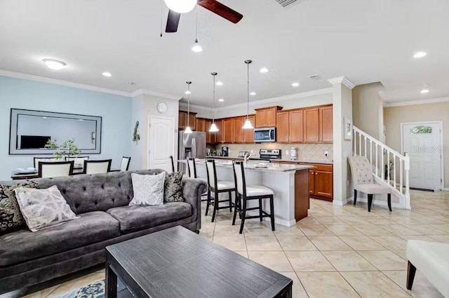 living room featuring ornamental molding, ceiling fan, and light tile patterned flooring