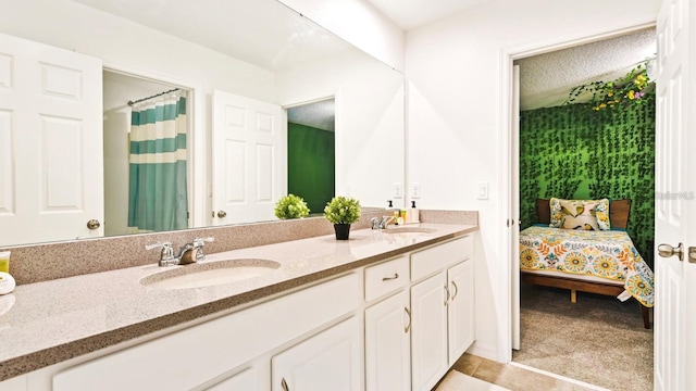 bathroom featuring vanity with extensive cabinet space, tile floors, and double sink