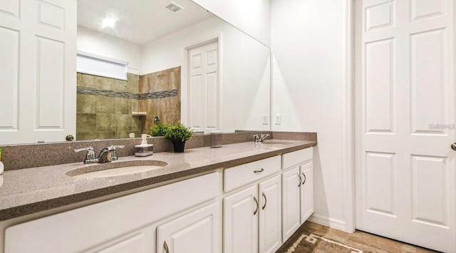 bathroom with tile flooring and dual bowl vanity